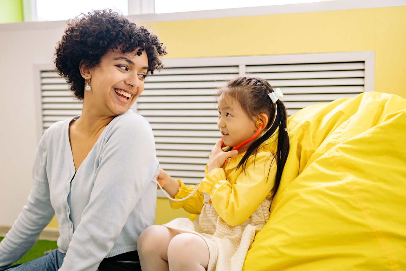 A doctor smiling warmly with a young patient